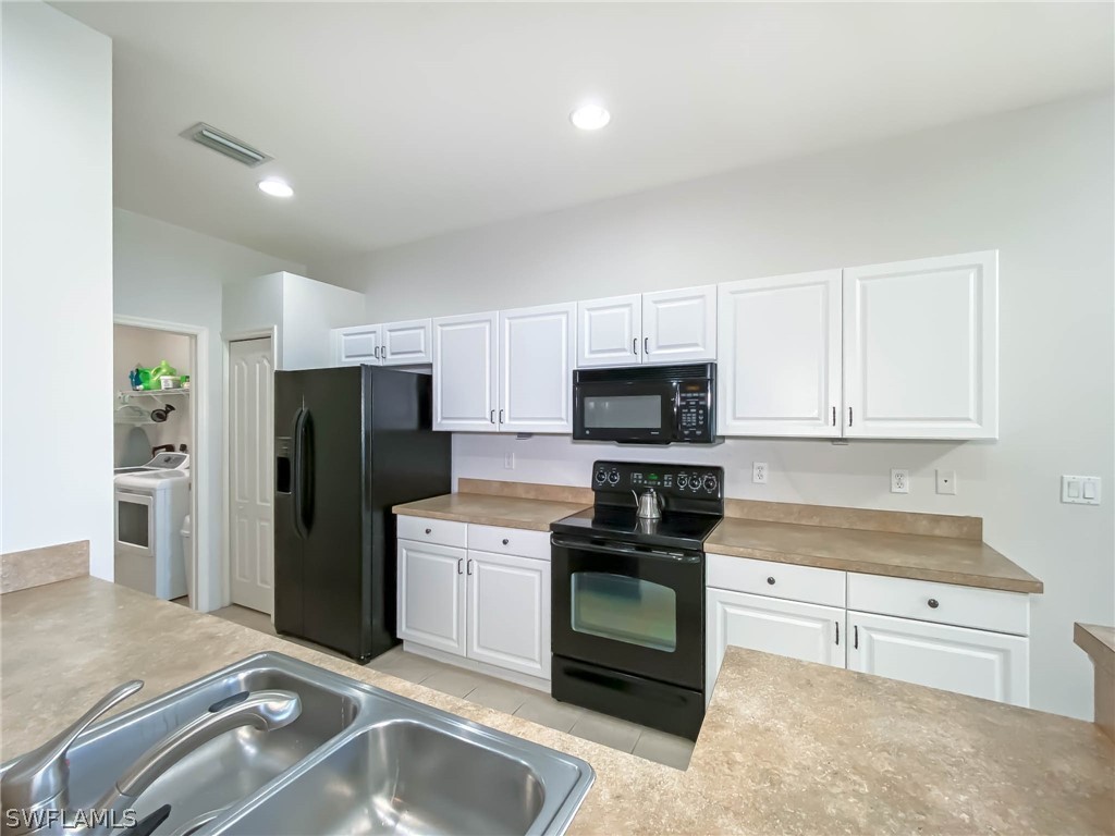 20599 Ardore Lane Estero, FL 33928 - Photo 13 of 29 a kitchen with stainless steel appliances granite countertop a refrigerator sink and stove