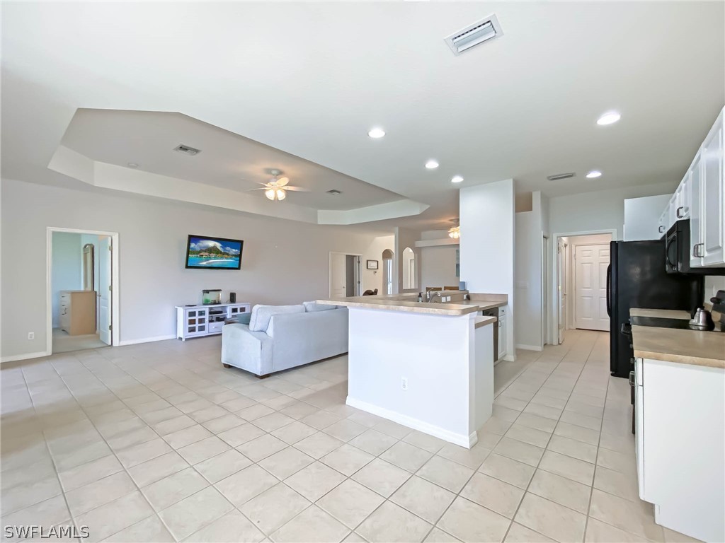 20599 Ardore Lane Estero, FL 33928 - Photo 14 of 29 a kitchen with kitchen island cabinets and refrigerator