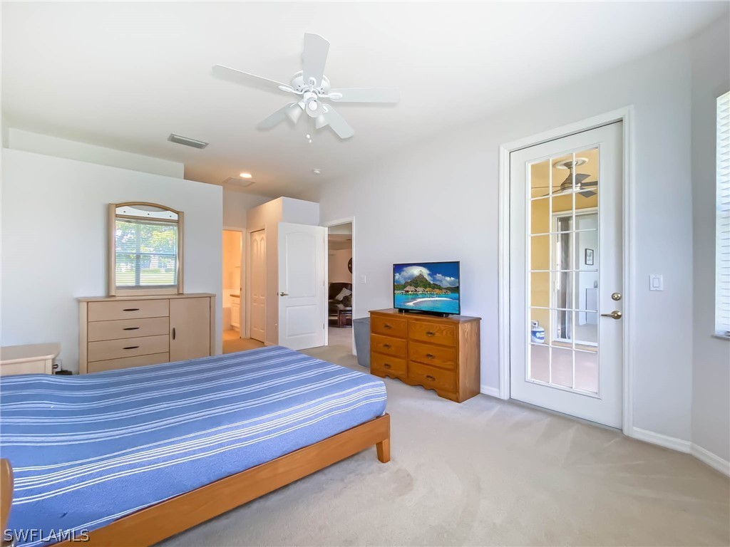 20599 Ardore Lane Estero, FL 33928 - Photo 18 of 29 a bedroom with a bed and a dresser