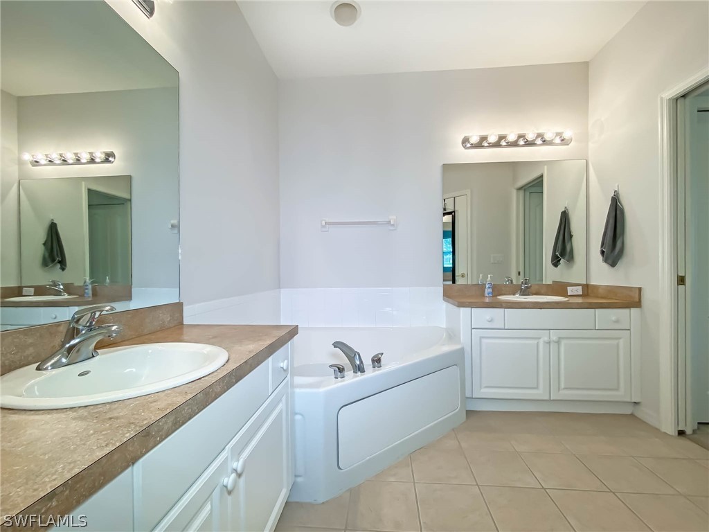 20599 Ardore Lane Estero, FL 33928 - Photo 21 of 29 a bathroom with a sink and a mirror