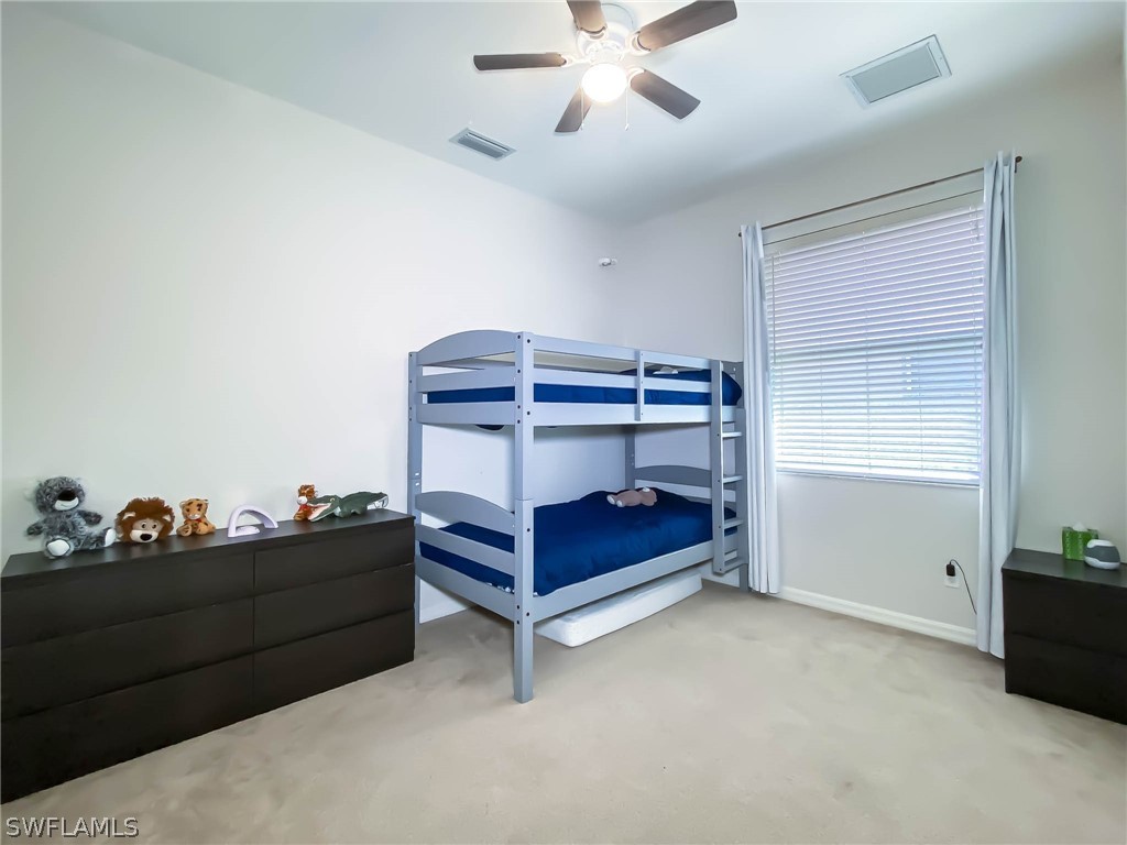 20599 Ardore Lane Estero, FL 33928 - Photo 22 of 29 a bedroom with a bed and window