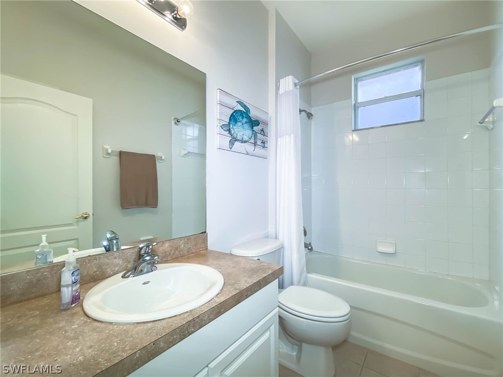 20599 Ardore Lane Estero, FL 33928 - Photo 24 of 29 a bathroom with a sink a toilet and a mirror