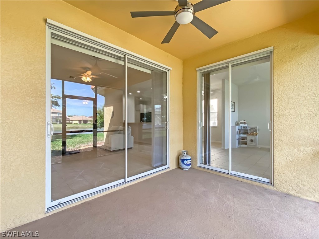 20599 Ardore Lane Estero, FL 33928 - Photo 27 of 29 a view of a hallway with a glass door