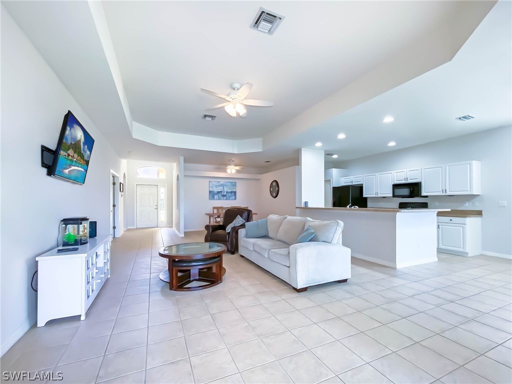 20599 Ardore Lane Estero, FL 33928 - Photo 4 of 29 a living room with furniture and kitchen view