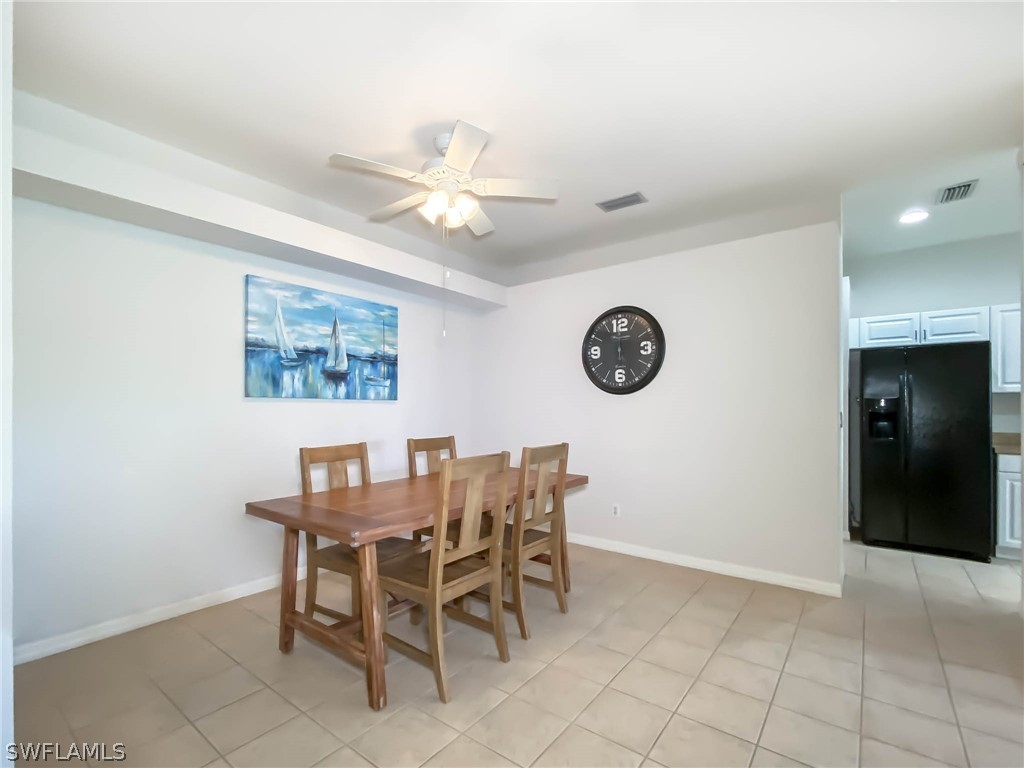 20599 Ardore Lane Estero, FL 33928 - Photo 5 of 29 a view of a dining room and chandelier fan