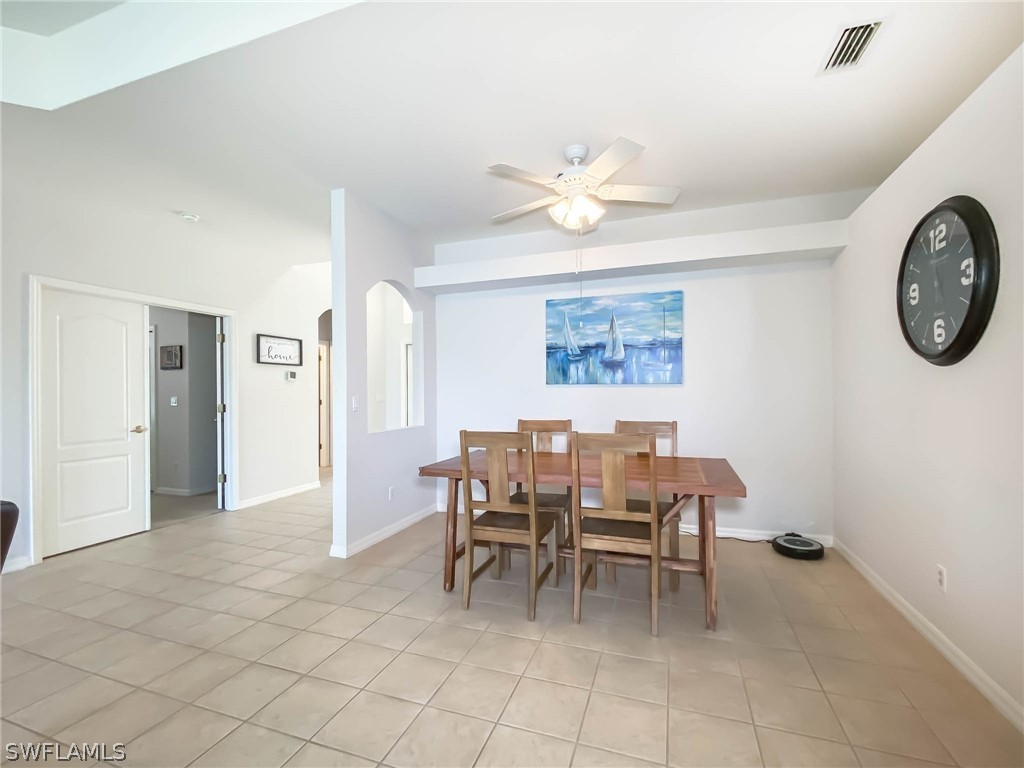 20599 Ardore Lane Estero, FL 33928 - Photo 6 of 29 a dining room with furniture and a large window