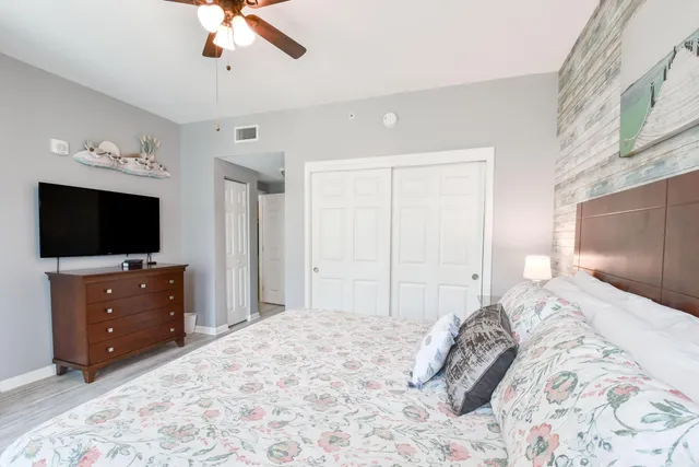 a bedroom with a bed and a flat screen tv