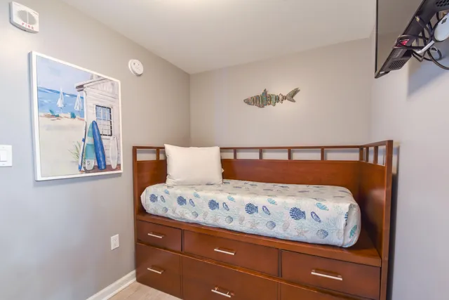 a bedroom with a bed and painting on the wall