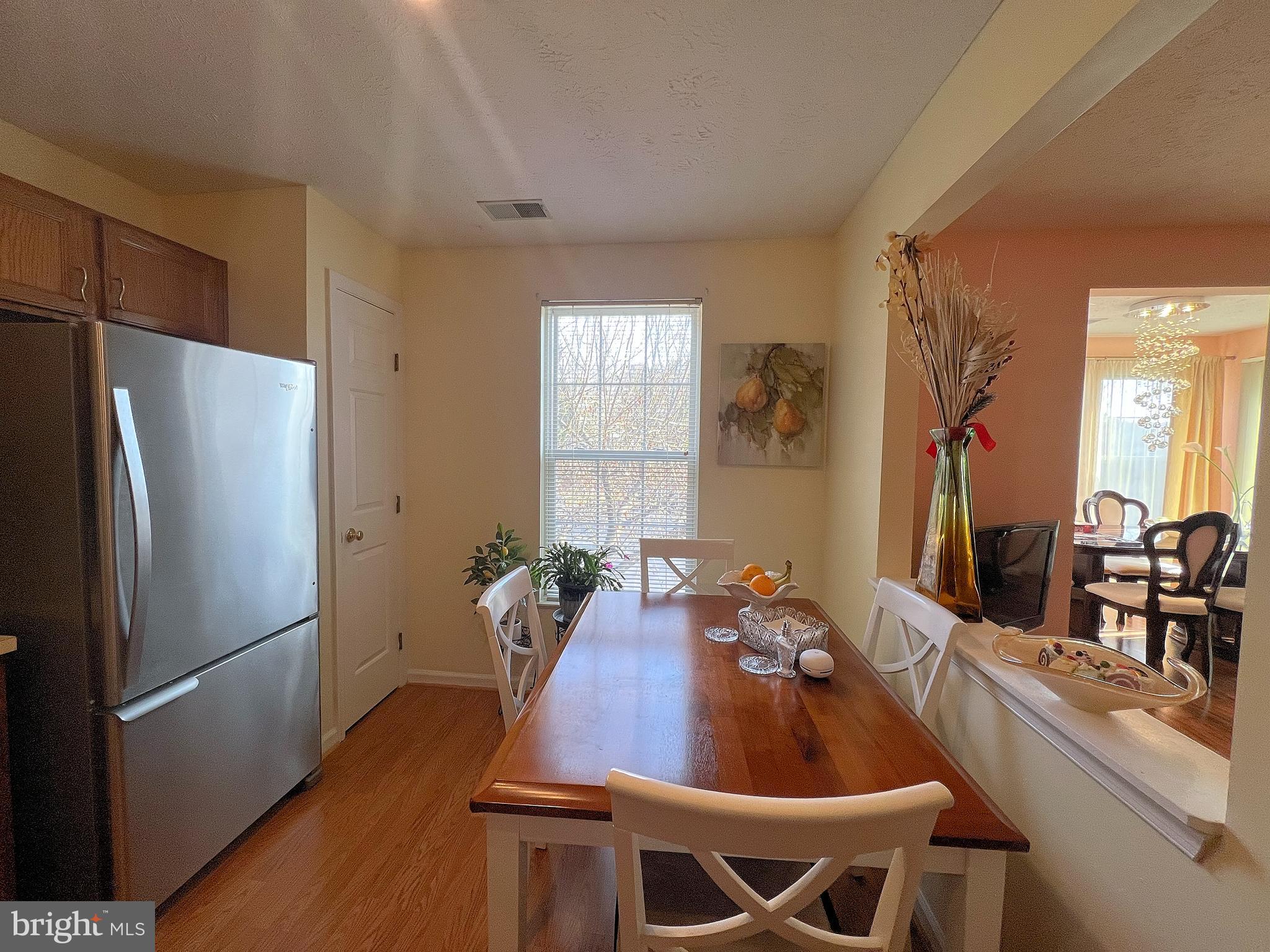 7903 Valley Manor Road, Unit 204 Owings Mills, MD 21117 - Photo 11 of 18 a dining room with furniture and window