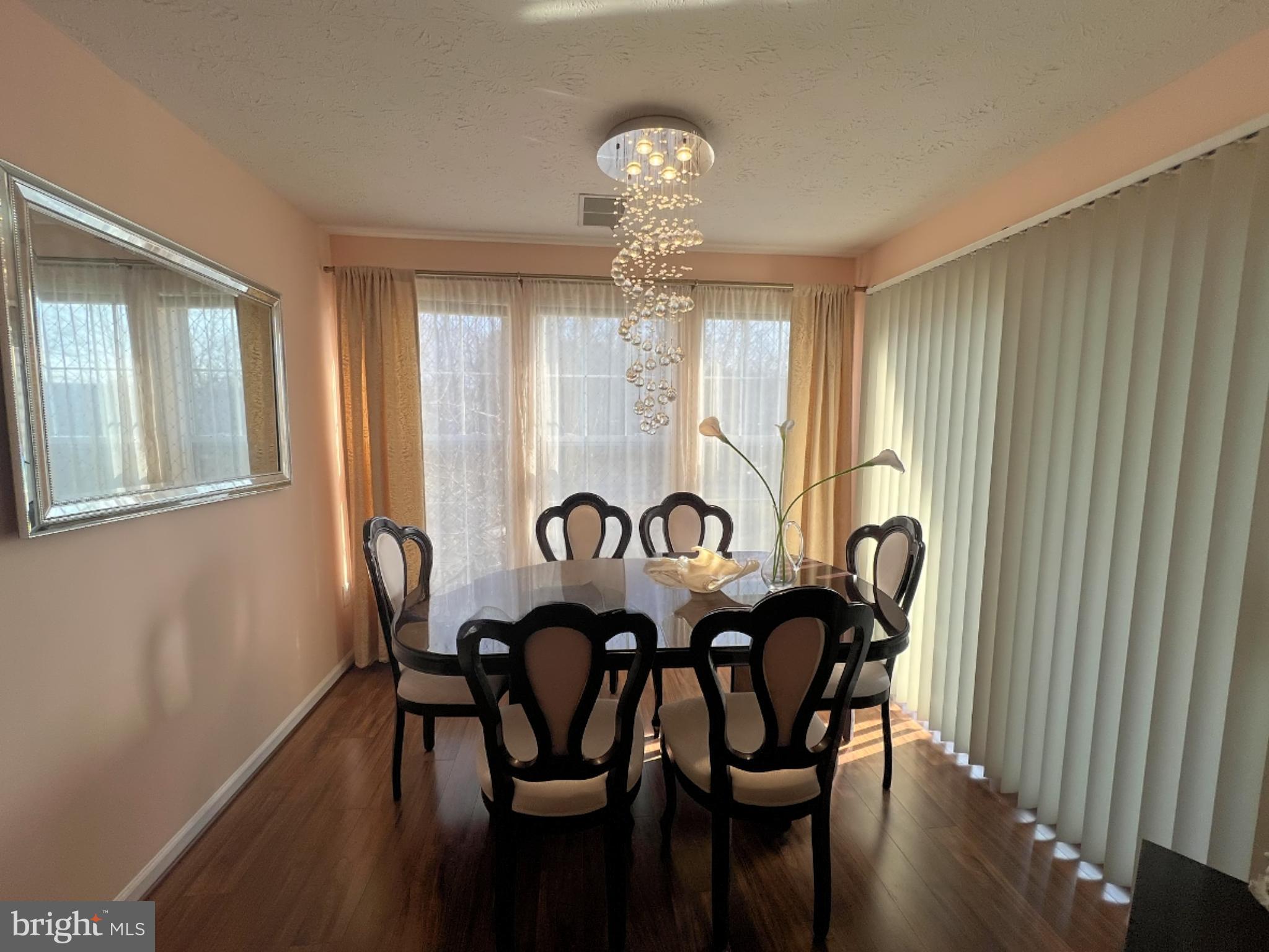 7903 Valley Manor Road, Unit 204 Owings Mills, MD 21117 - Photo 13 of 18 a view of a dining room with furniture window and wooden floor