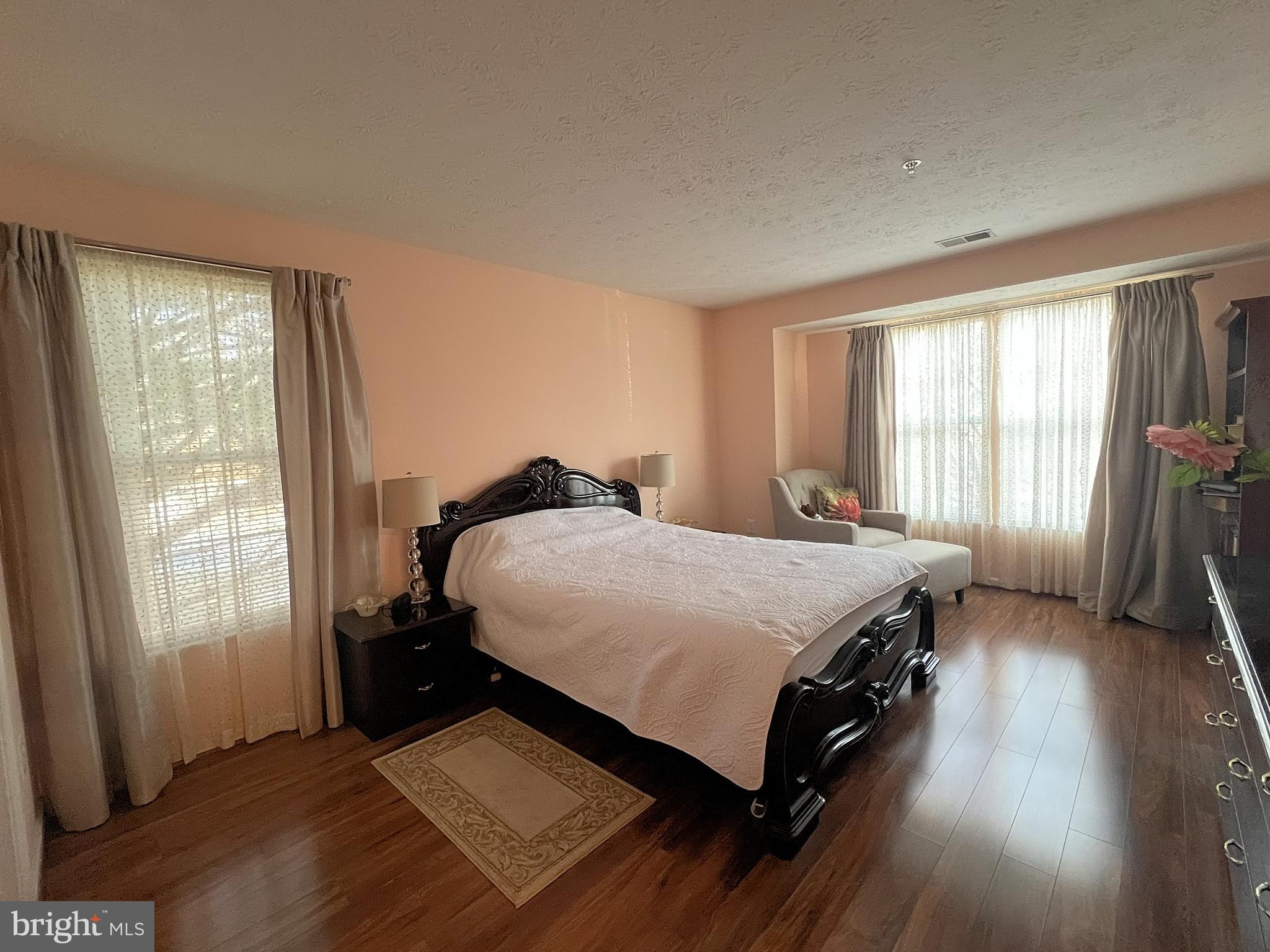 7903 Valley Manor Road, Unit 204 Owings Mills, MD 21117 - Photo 15 of 18 a bed sitting in a bedroom next to a window