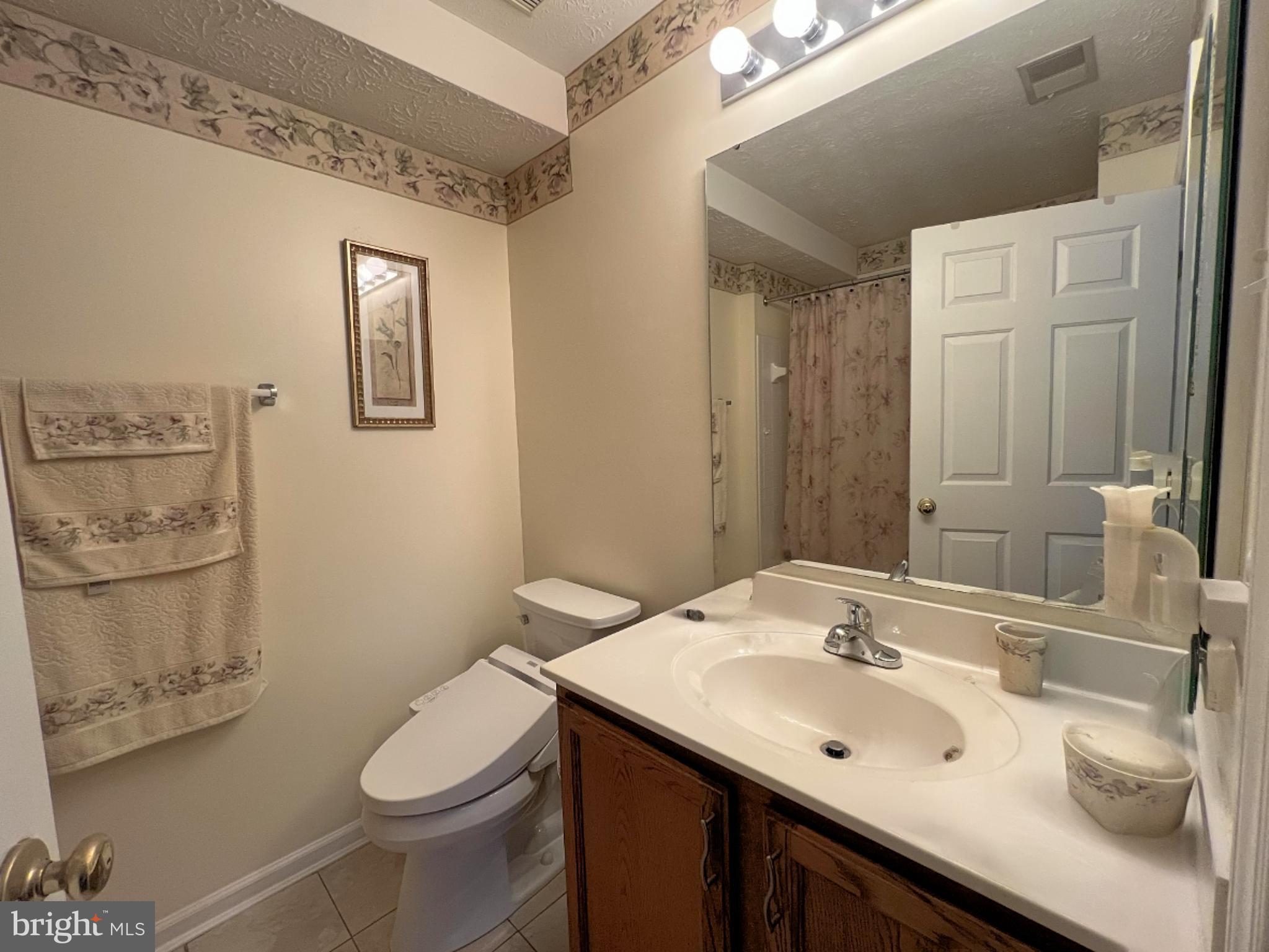 7903 Valley Manor Road, Unit 204 Owings Mills, MD 21117 - Photo 17 of 18 a bathroom with a sink toilet and mirror
