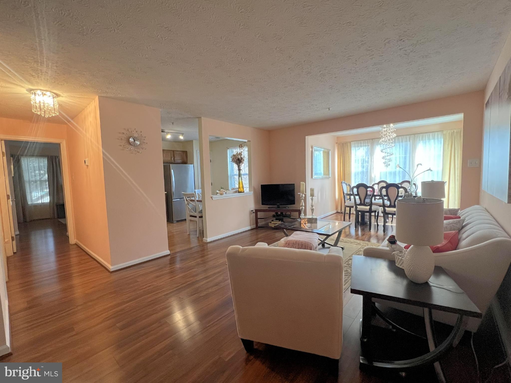 7903 Valley Manor Road, Unit 204 Owings Mills, MD 21117 - Photo 5 of 18 a view of a dining room with furniture window and wooden floor