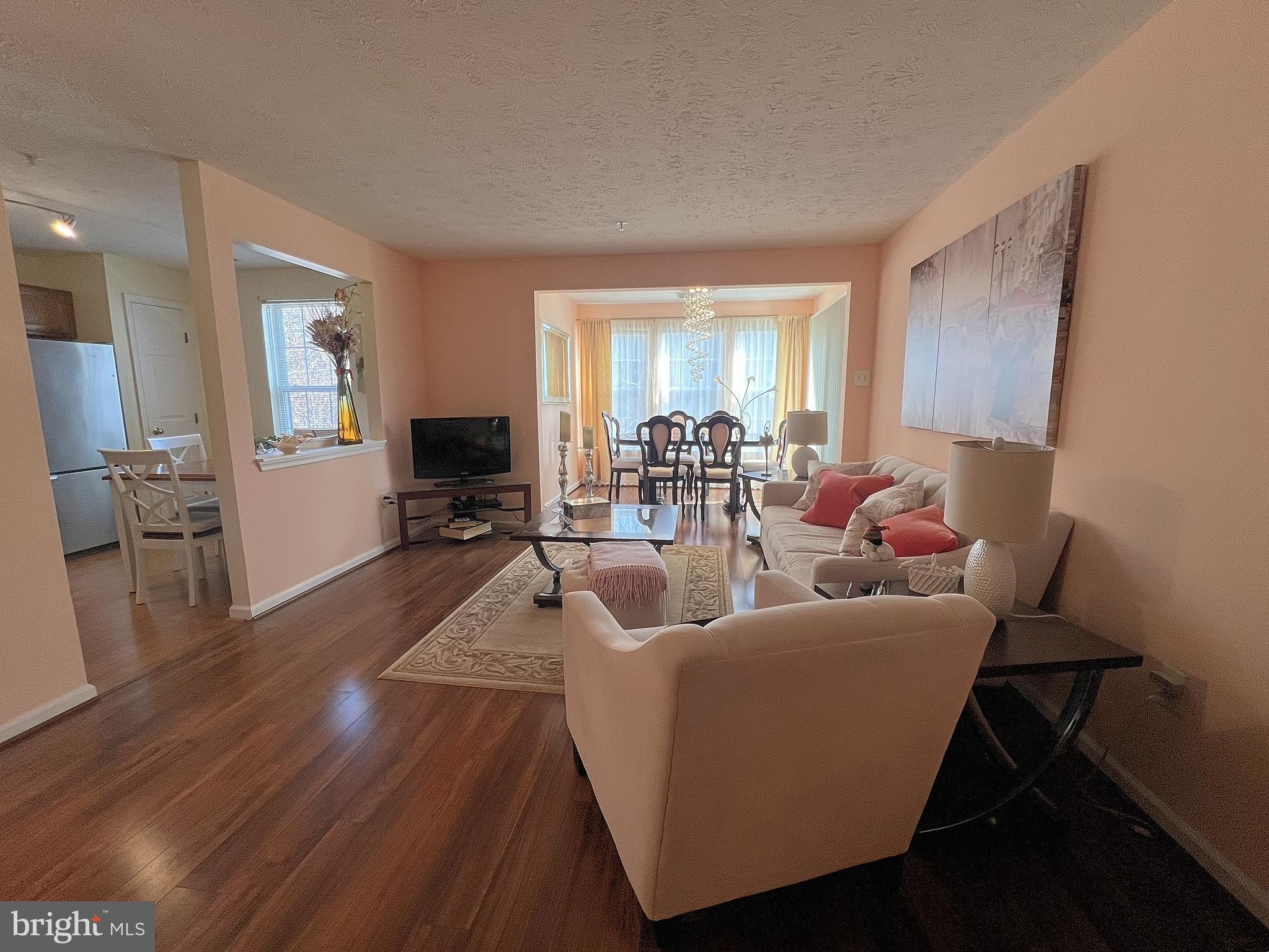 7903 Valley Manor Road, Unit 204 Owings Mills, MD 21117 - Photo 6 of 18 a living room with furniture and a wooden floor