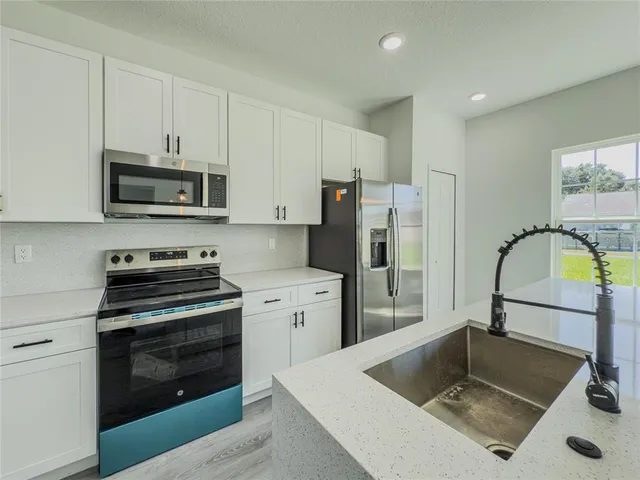 a view of a big room with wooden floor and a window