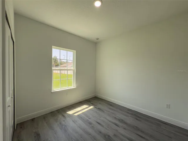 an empty room with wooden floor