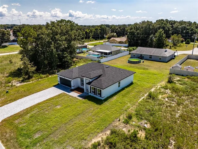 a view of a swimming pool with lounge chairs