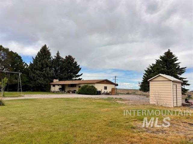 3197 Neeley Road American Falls, ID 83211 - Photo 38 of 45 Spacious lot featuring a single-story residence with a covered front porch and mature trees