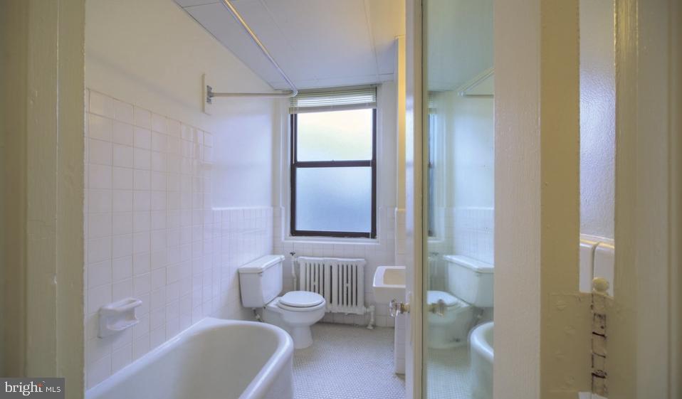 3902 Chestnut Street, Unit 2B1BA Philadelphia, PA 19104 - Photo 10 of 17 a bathroom with a bathtub toilet and sink