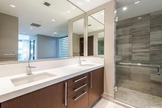 a bathroom with a sink double vanity and a shower