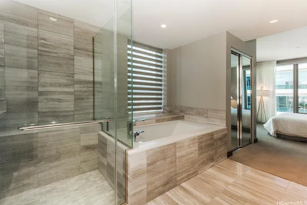 a bathroom with a tub and shower