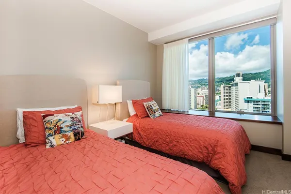 a bedroom with a large bed and a large window