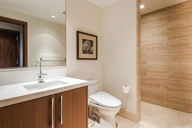 a bathroom with a sink a toilet and mirror