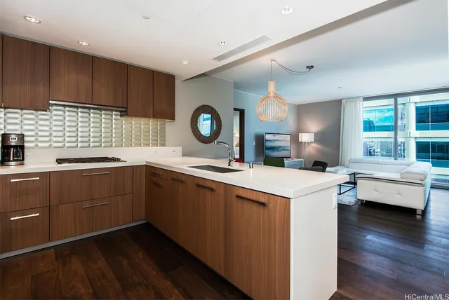 a kitchen with a sink cabinets and wooden floor