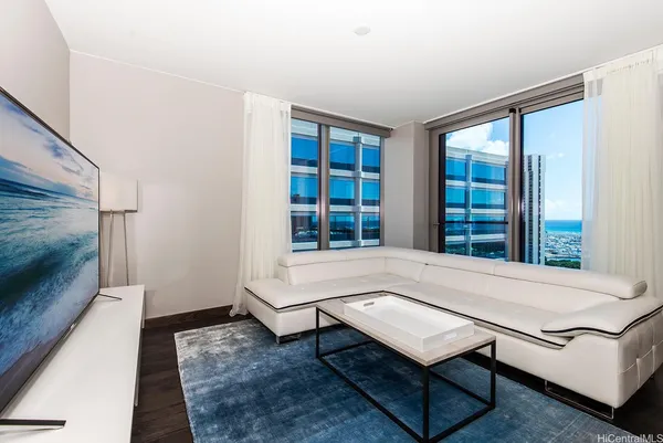 a living room with furniture a rug and a large window