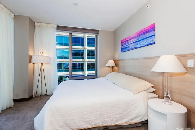 a bedroom with a bed and a lamp