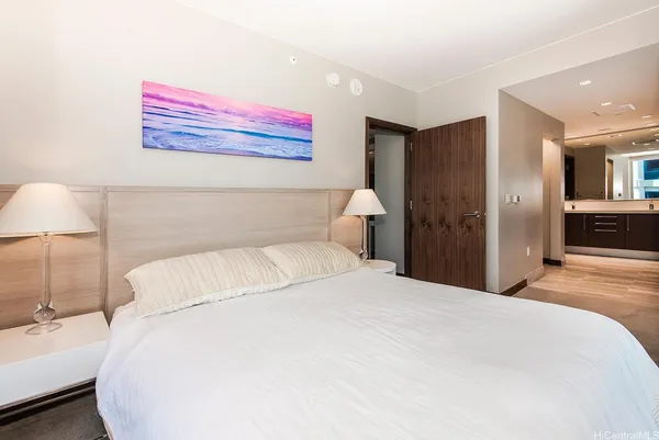 a bedroom with a bed and a chandelier