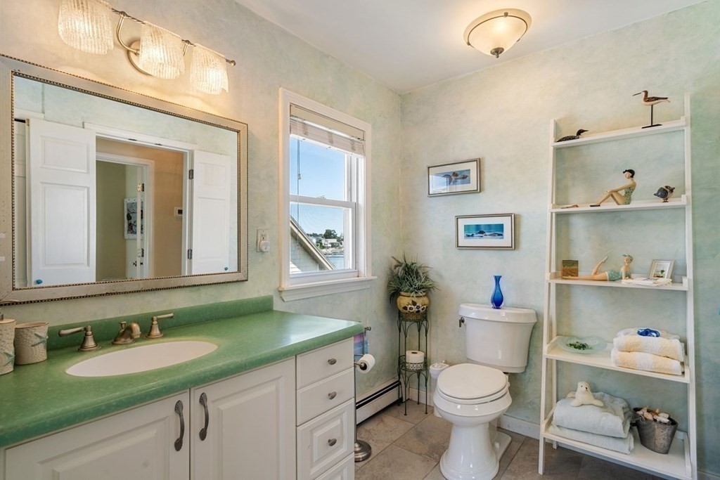 225 Nantasket Road Hull, MA 02045 - Photo 30 of 40 a bathroom with a granite countertop toilet sink and mirror