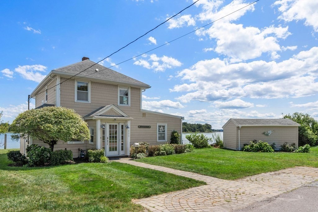 225 Nantasket Road Hull, MA 02045 - Photo 3 of 40 a front view of a house with a yard and garage