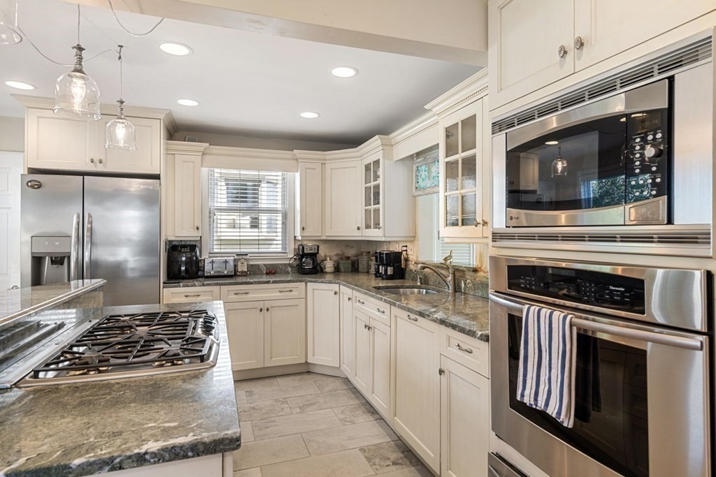225 Nantasket Road Hull, MA 02045 - Photo 7 of 40 a kitchen with a stove sink and refrigerator