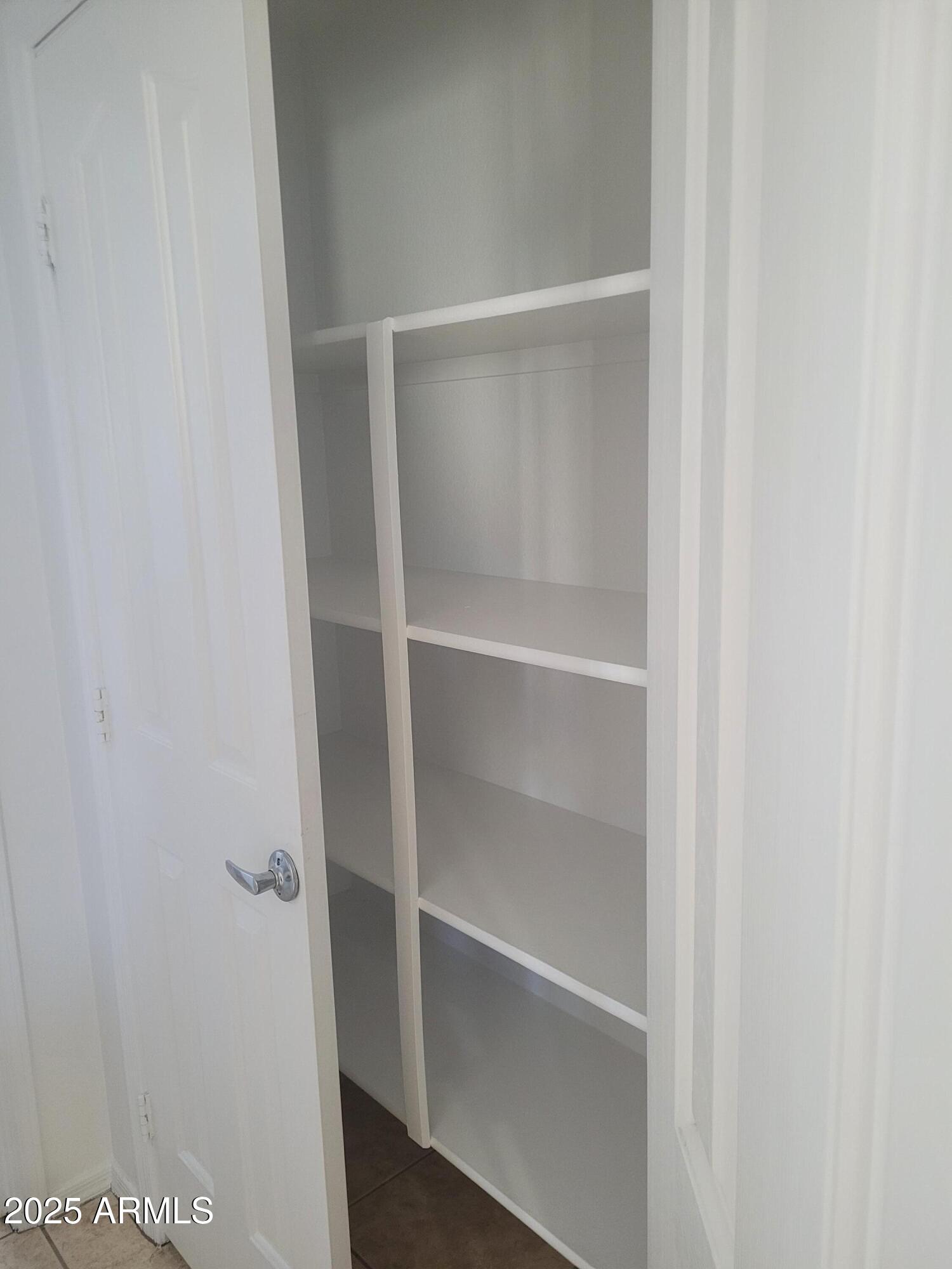 280 South Evergreen Road, Unit 1312 Tempe, AZ 85288 - Photo 10 of 25 a view of walk in closet with empty racks