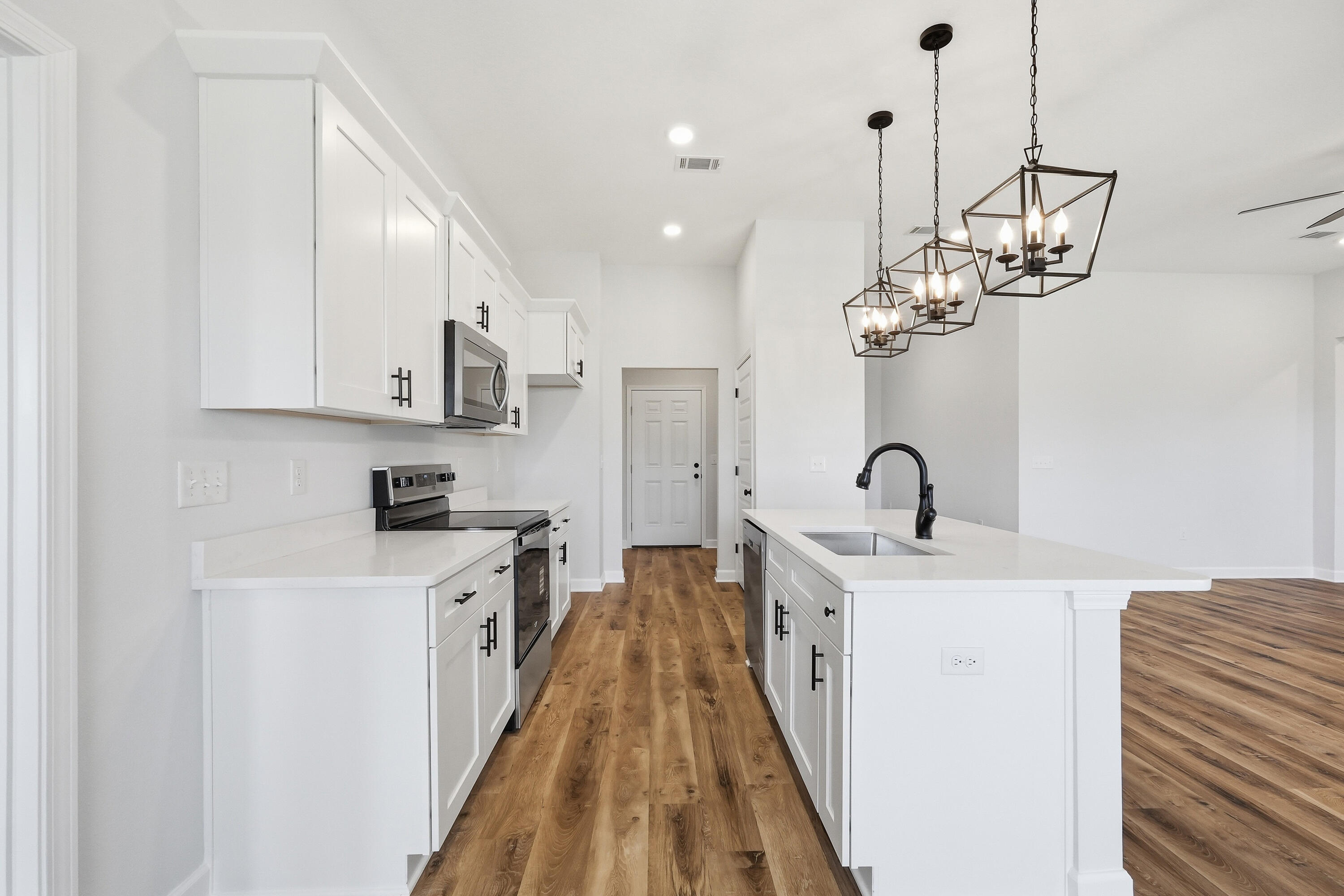 2801 Blackbird Court Crestview, FL 32539 - Photo 11 of 26 a kitchen with stainless steel appliances granite countertop a sink dishwasher a refrigerator and a stove with wooden floor