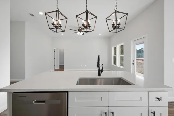 a kitchen with a sink and chandelier