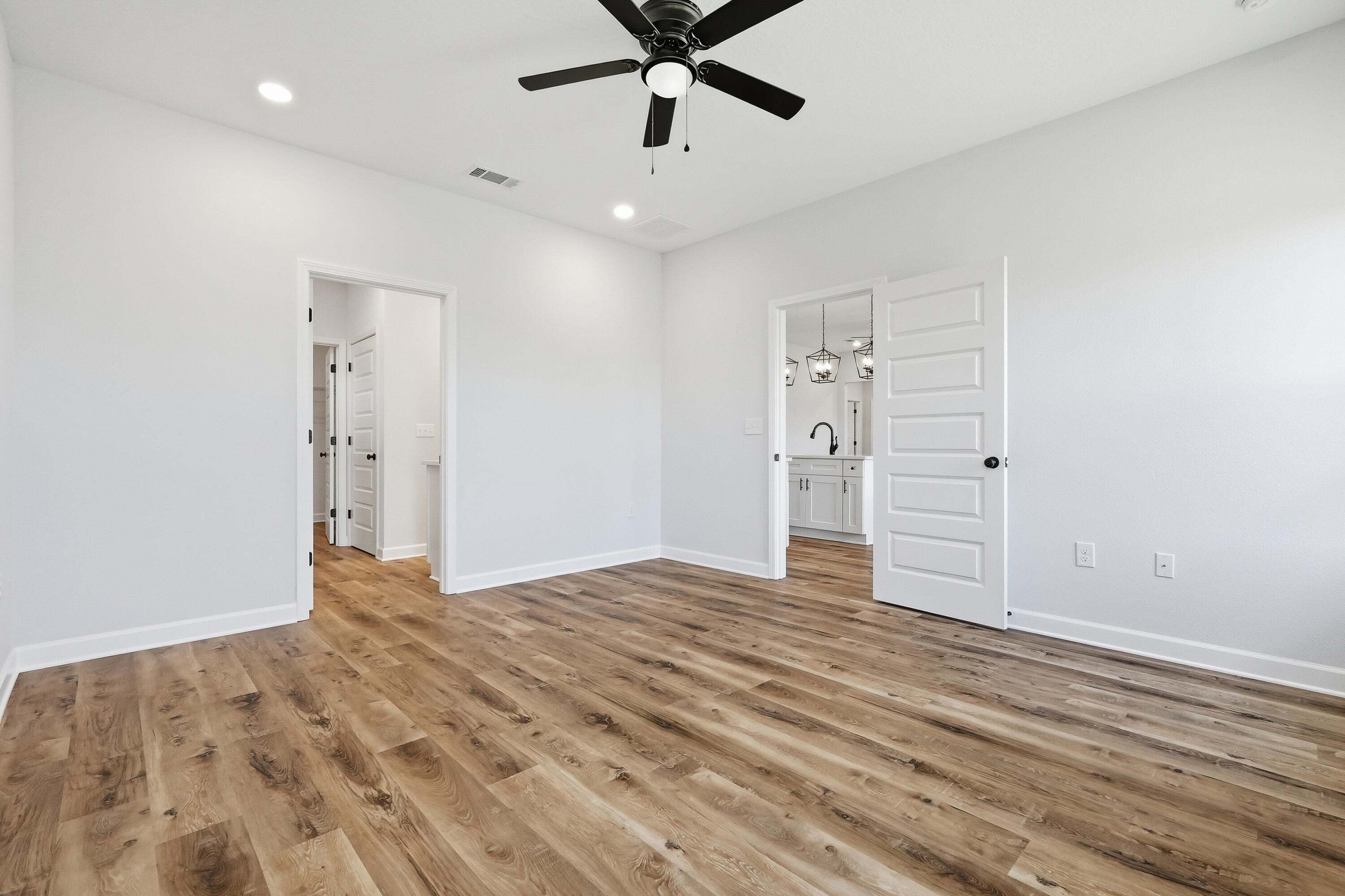 2801 Blackbird Court Crestview, FL 32539 - Photo 14 of 26 a view of empty room with wooden floor and ceiling fan