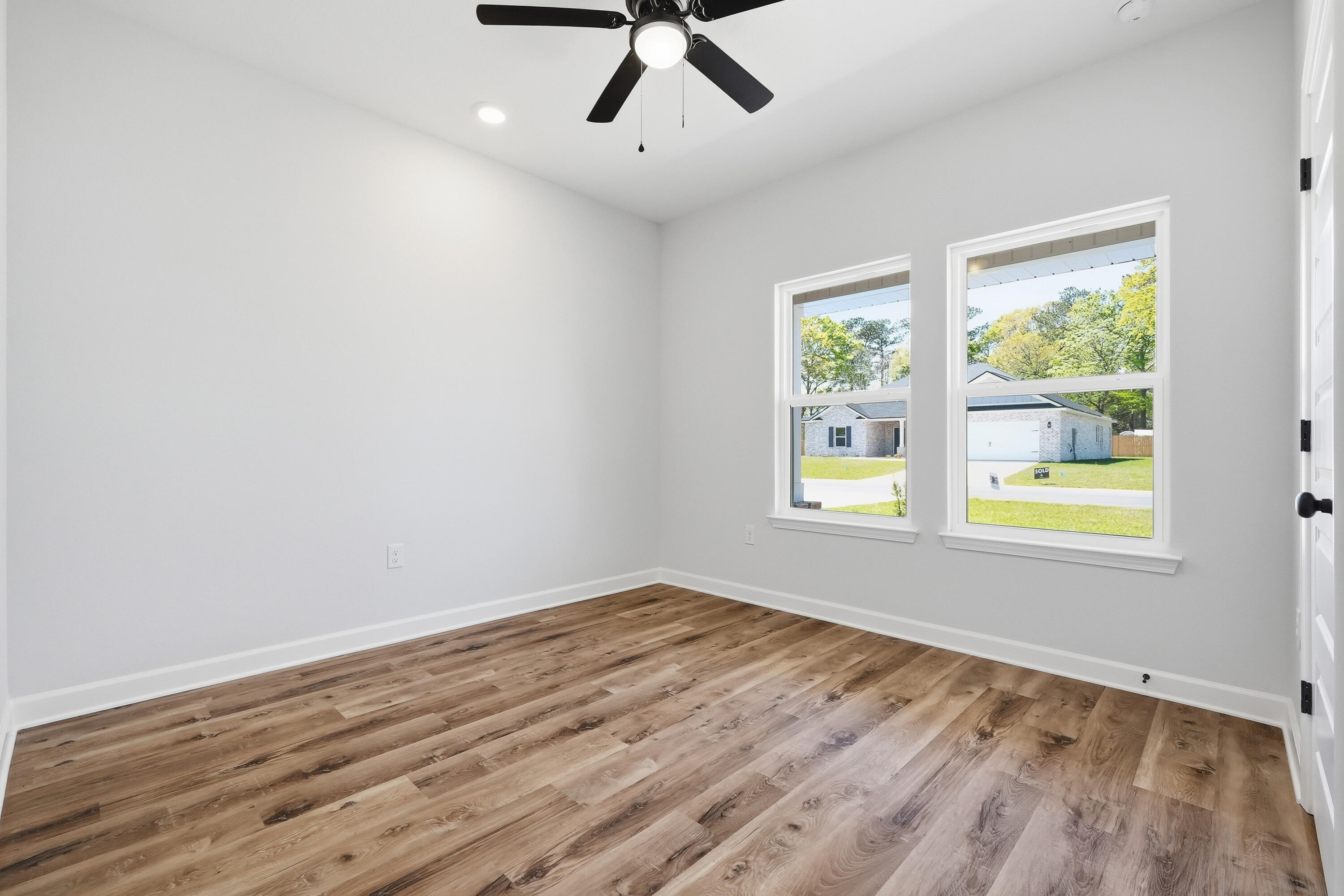 2801 Blackbird Court Crestview, FL 32539 - Photo 17 of 26 a view of an empty room with wooden floor and a window
