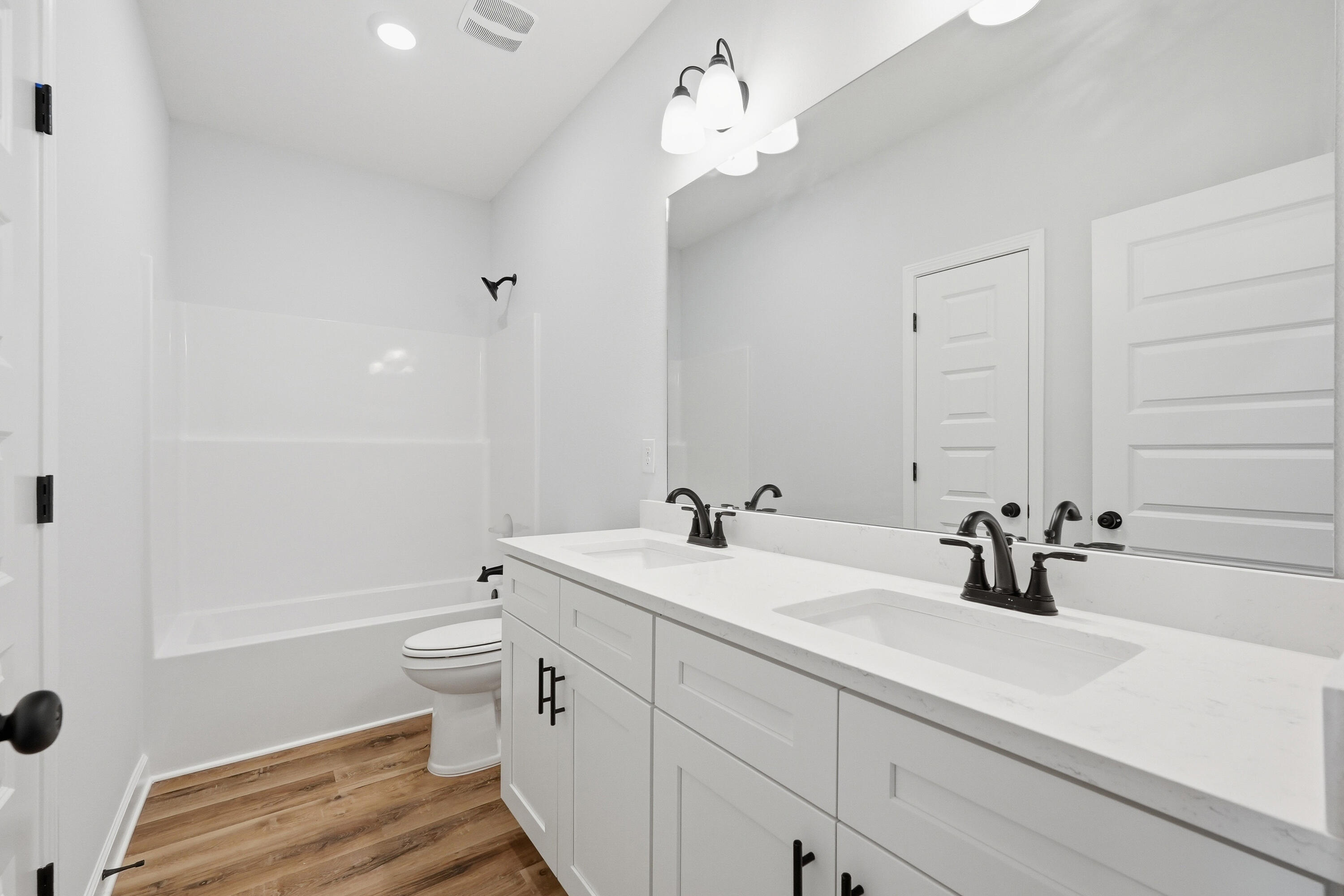 2801 Blackbird Court Crestview, FL 32539 - Photo 19 of 26 a bathroom with a double vanity sink toilet and shower