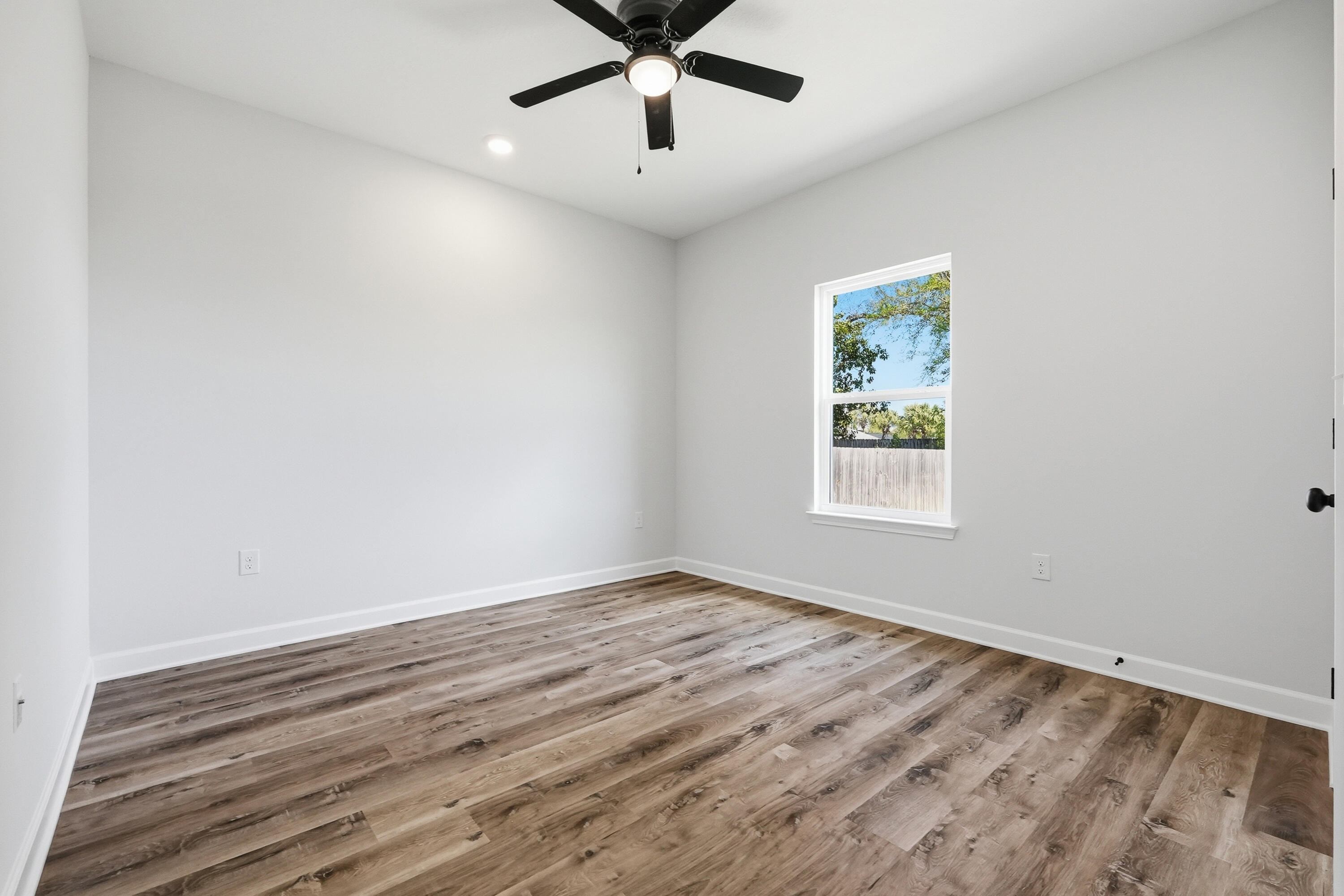 2801 Blackbird Court Crestview, FL 32539 - Photo 20 of 26 wooden floor in an empty room with a window