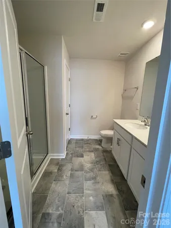 a bathroom with a sink a toilet and a shower