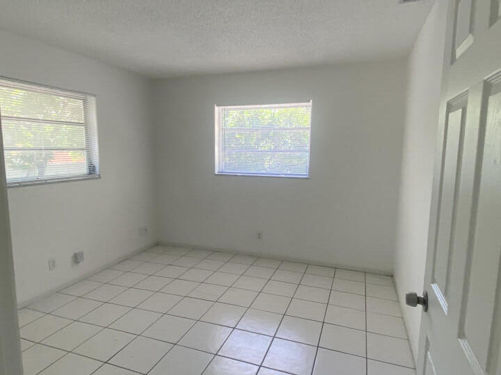 1718 Juno Road, Unit 2 North Palm Beach, FL 33408 - Photo 3 of 9 an empty room with windows