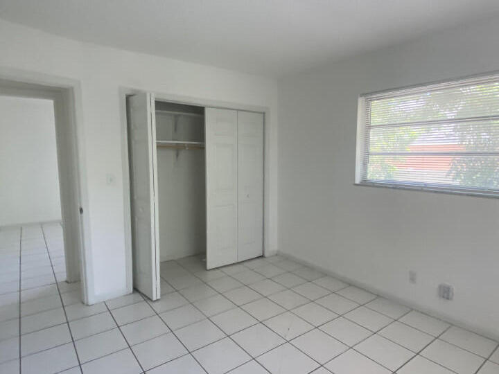 1718 Juno Road, Unit 2 North Palm Beach, FL 33408 - Photo 4 of 9 an empty room with windows