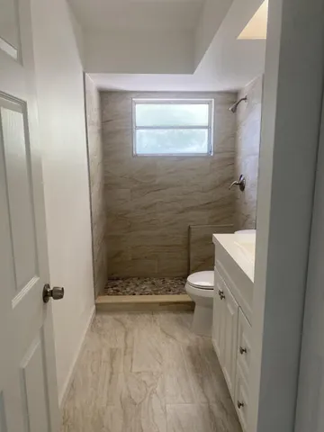 a bathroom with a toilet and a shower
