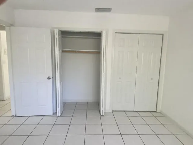 a view of a utility room with cabinet