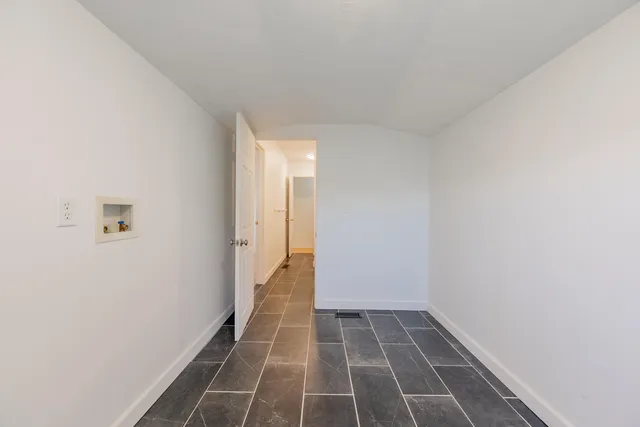 a bed room with a bed and a chair