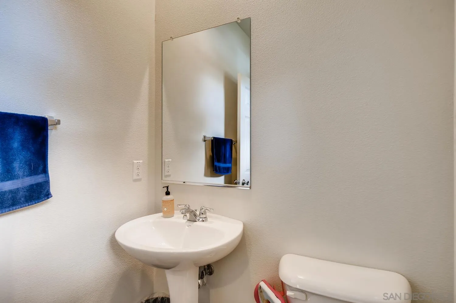 1223 Mason Road Chula Vista, CA 91913 - Photo 11 of 24 a bathroom with a toilet sink and mirror