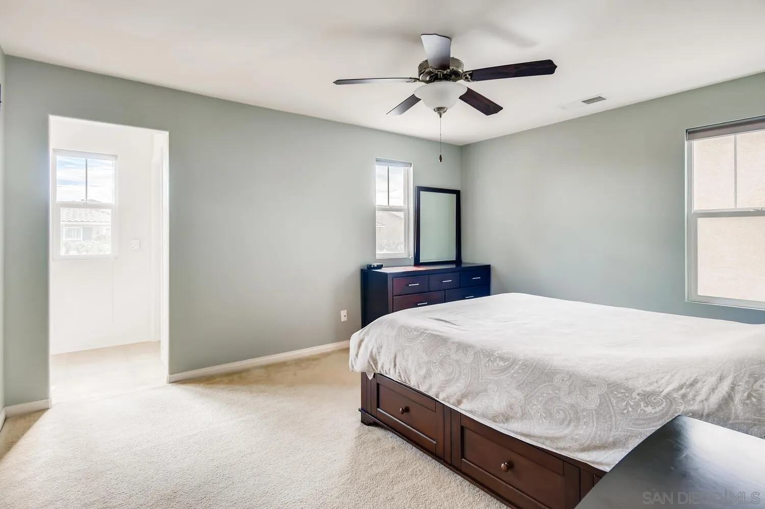 1223 Mason Road Chula Vista, CA 91913 - Photo 13 of 24 a bedroom with a large bed and a chandelier