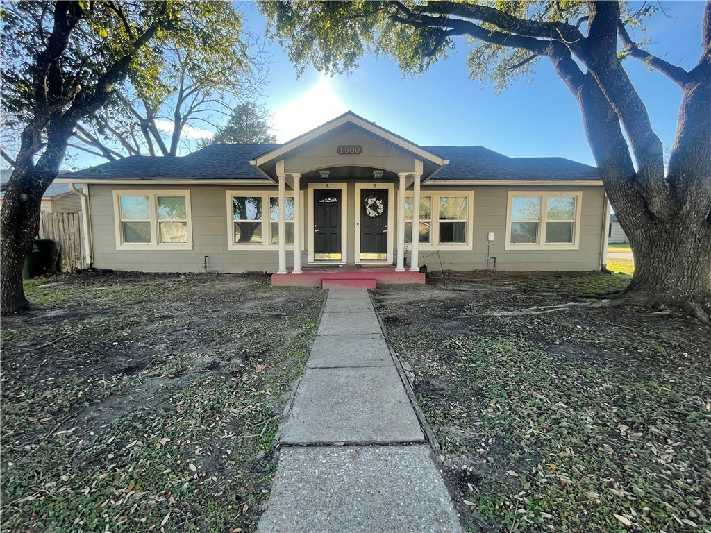 a front view of a house with a yard and a garage